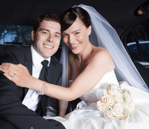 Plan Now for Wedding Smile-min Newly wed bride in groom smiling in the back of a limo