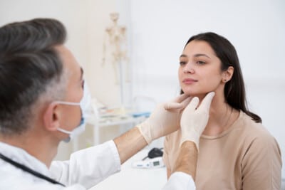 Doctor examining a patient's throat during a checkup in a medical office