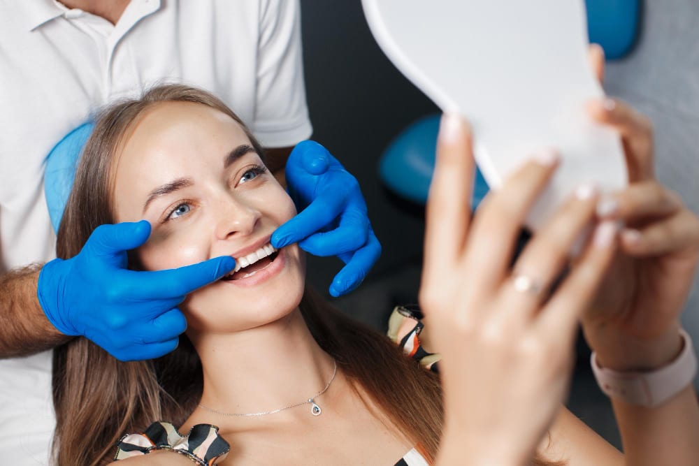 Dentist adjusting a patient's smile with dental veneers