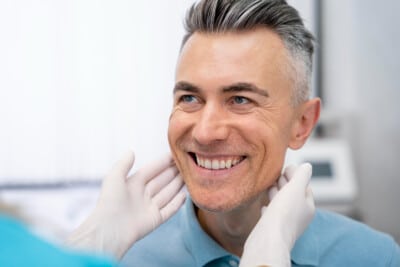 Close-up of a smiling man in a doctor's office