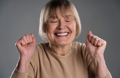 Close-up of an older woman smiling widely