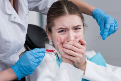 Woman with a toothache sitting in a dentist's chair