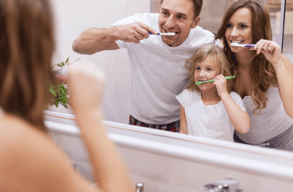 Family brushing their teeth together