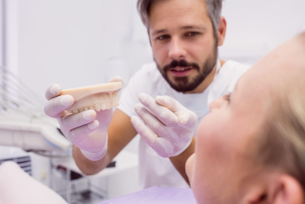 Dentist holding a dental bite splint