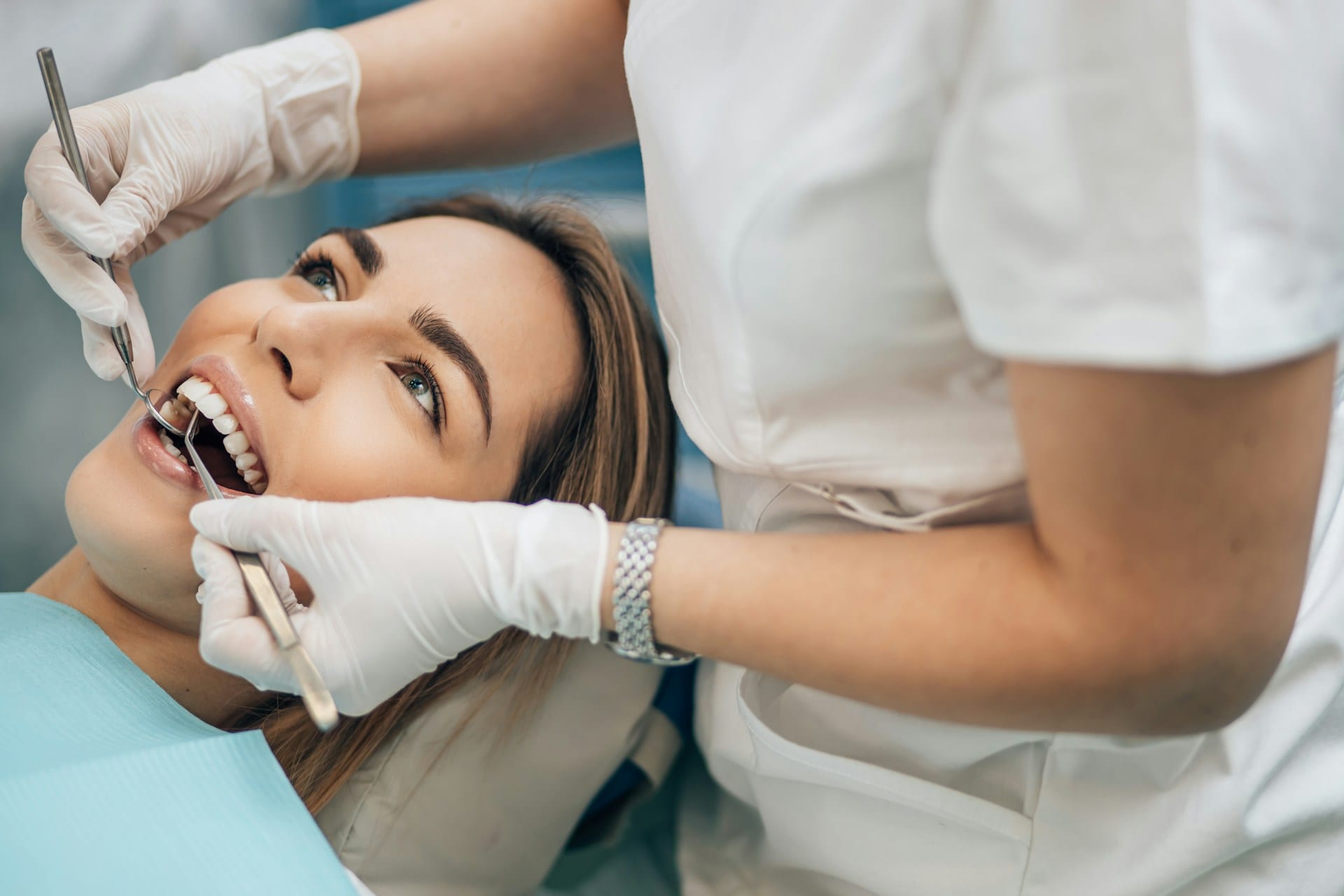 Young woman lying in a dental chair with open mouth