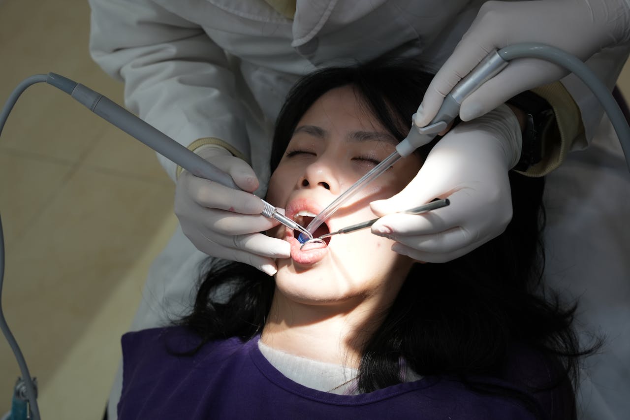 Patient with closed eyes receiving dental treatment