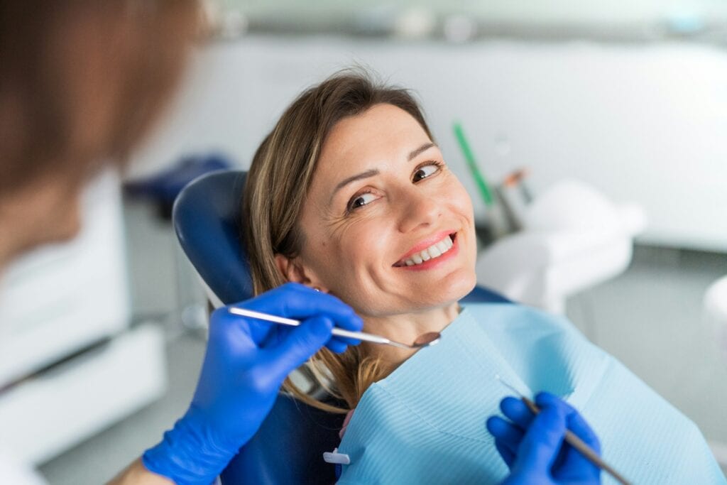 Smiling woman sitting comfortably in a dental chair
