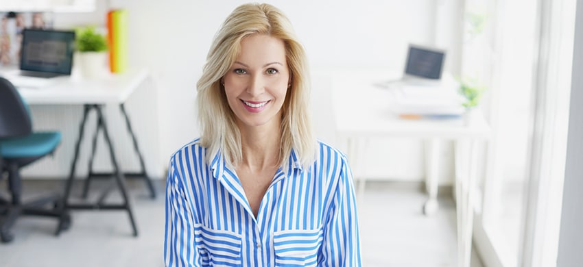 Businesswoman in the office. Portrait of a smiling blond busines