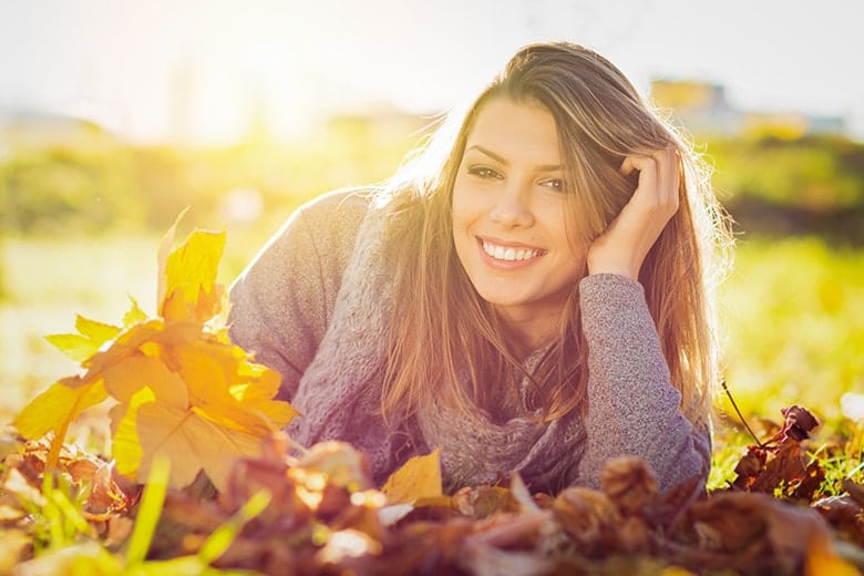 young woman relaxing in a fall field