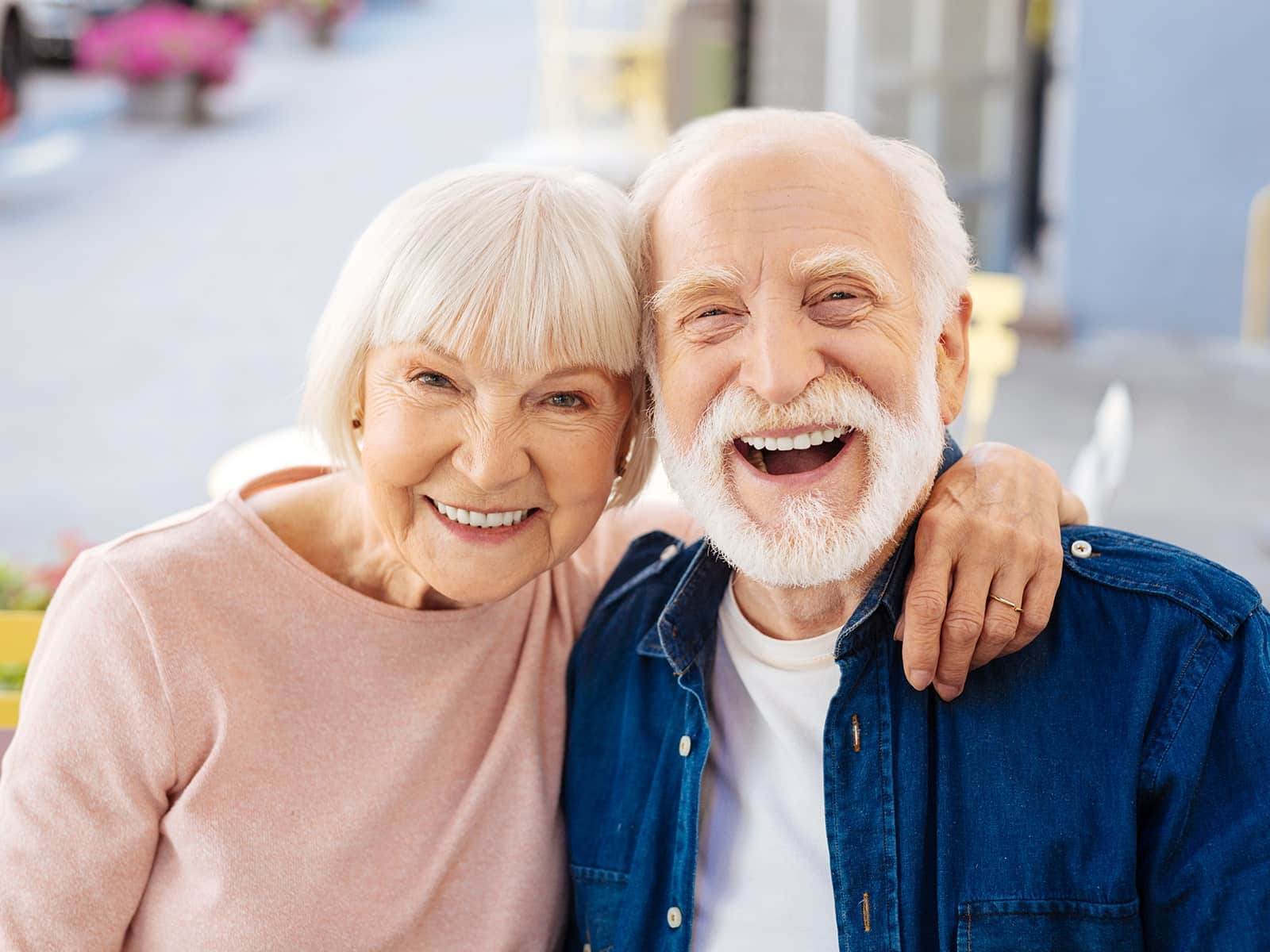 Elderly couple smiling on their back patio